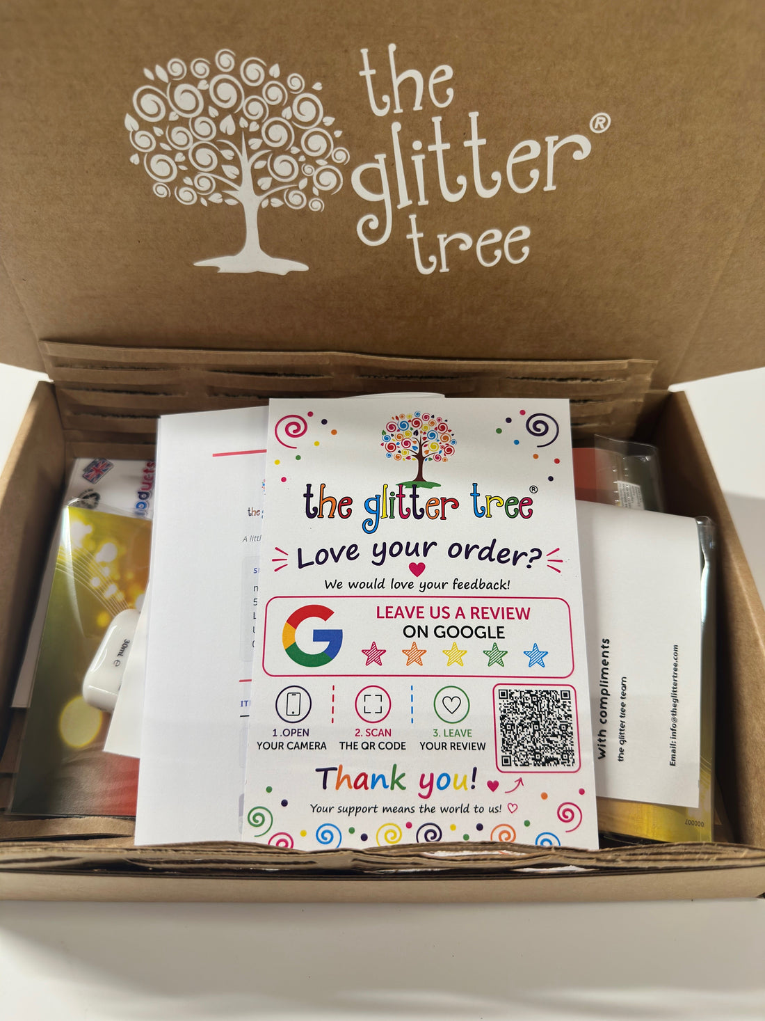 Open Glitter Tree printed box with a Love your order card, compliments slip and an order packed inside