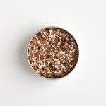 Close-up of The Glitter Tree Burnt Orange biodegradable cosmetic glitter pot showing the glitter inside