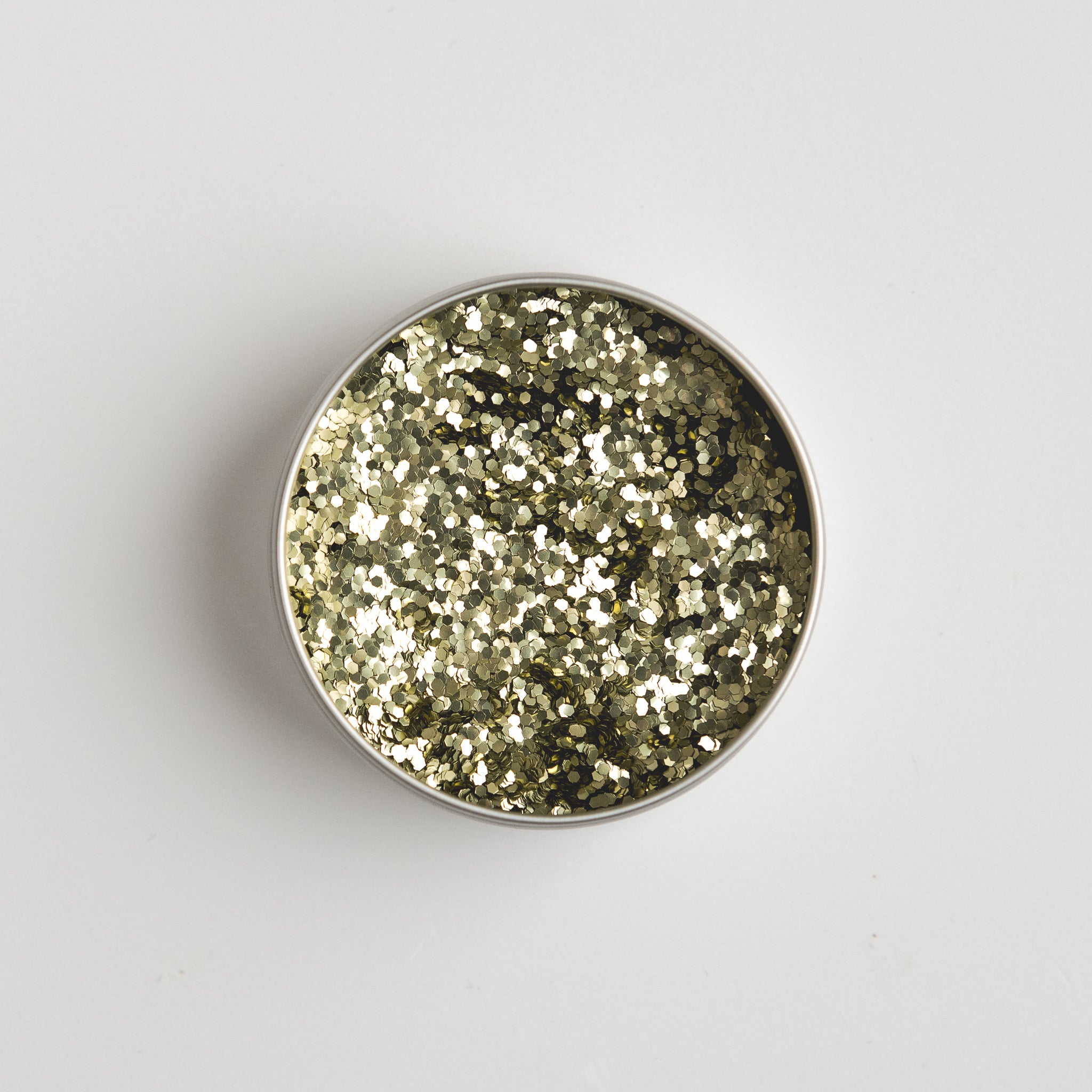 Close-up of The Glitter Tree Gold biodegradable cosmetic glitter pot showing the glitter inside