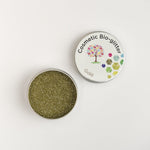 Open pot of The Glitter Tree Gold biodegradable cosmetic glitter showing the sparkle texture, next to a closed pot