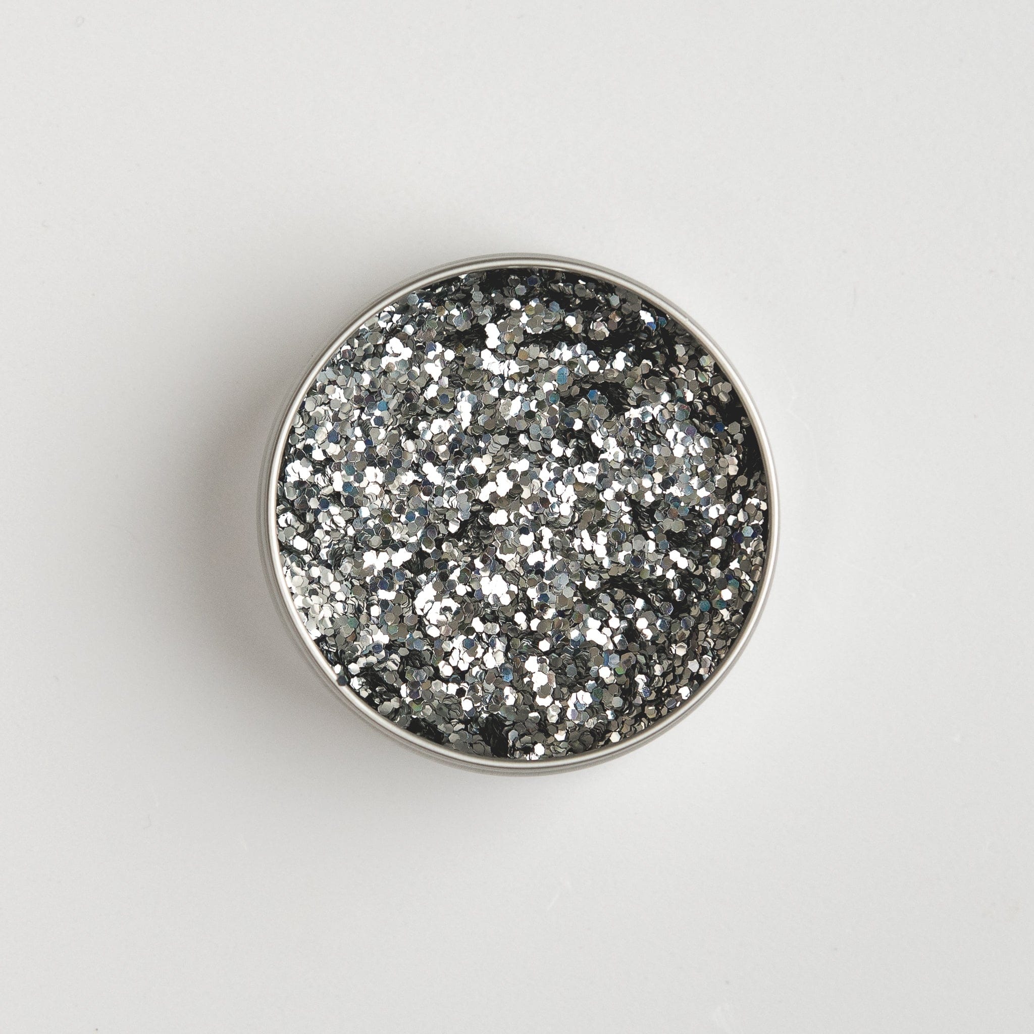Close-up of The Glitter Tree Holo Silver biodegradable cosmetic glitter pot showing the glitter inside