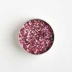 Close-up of The Glitter Tree Rose Pink biodegradable cosmetic glitter tin showing the glitter inside