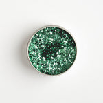 Close-up of The Glitter Tree Spring Green biodegradable cosmetic glitter tin showing the glitter inside