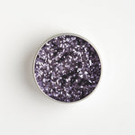 Close-up of The Glitter Tree Violet biodegradable cosmetic glitter tin showing the glitter inside